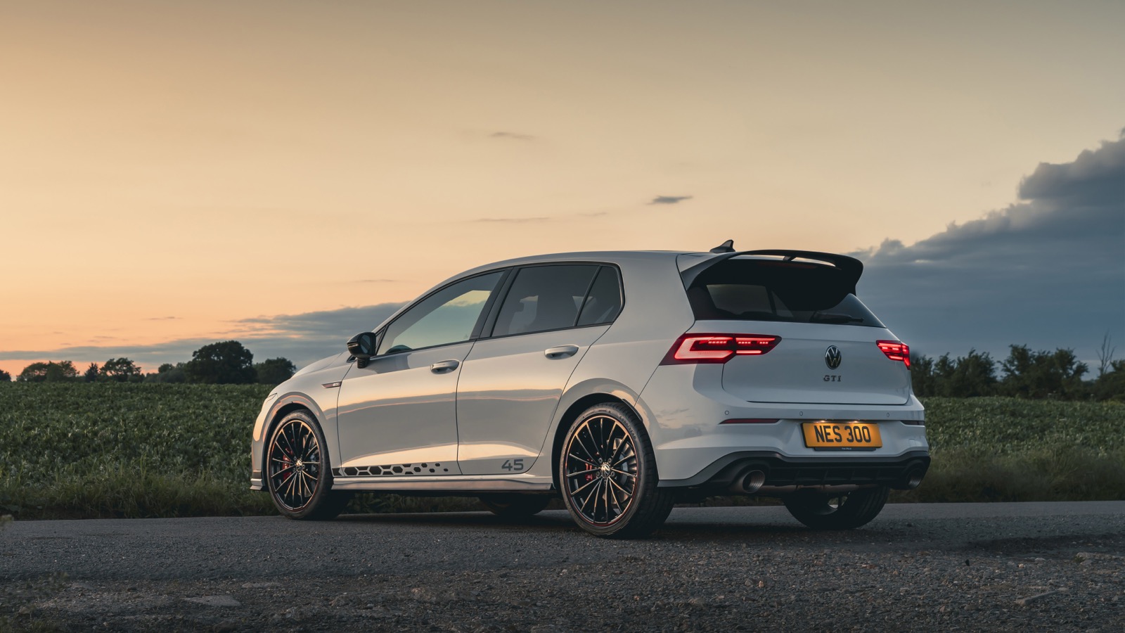 Volkswagen Golf GTI parked in a field at sunset — placeholder automotive photography